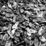 Black and white photograph of a pile of shoes