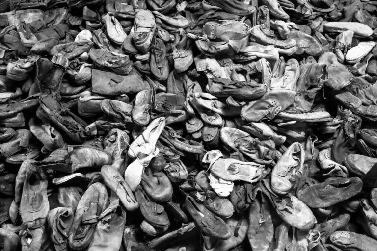 Black and white photograph of a pile of shoes